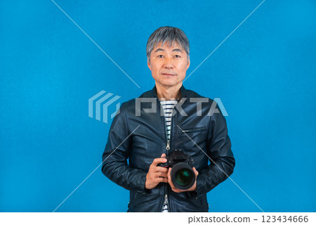 Smiling senior man with a camera Smiling senior man with a camera 123434666