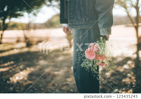 A woman in denim holding a bouquet 123435245