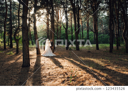walk of the bride and groom through the autumn forest 123435526