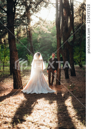 walk of the bride and groom through the autumn forest 123435528