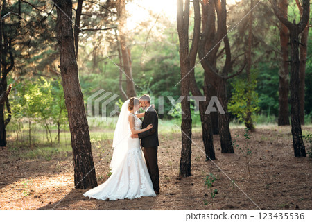 walk of the bride and groom through the autumn forest 123435536