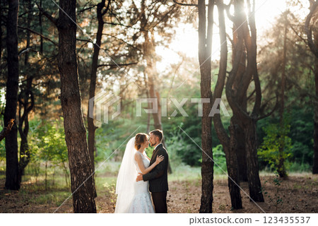 walk of the bride and groom through the autumn forest 123435537
