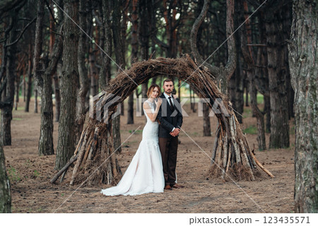walk of the bride and groom through the autumn forest 123435571