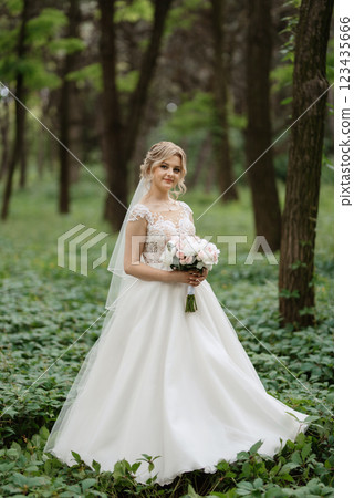 young girl bride in a white dress in a spring forest young girl bride in a white dress in a spring forest 123435666
