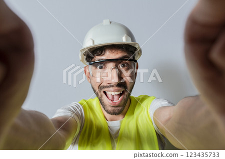 Smiling male engineer taking a selfie looking at camera. Funny builder engineer taking a selfie isolated, Engineer taking a selfie isolated. View of male engineer taking a selfie isolated Smiling male engineer taking a selfie looking at camera. Funny builder engineer taking a selfie isolated, Engineer taking a selfie isolated. View of male engineer taking a selfie isolated 123435733