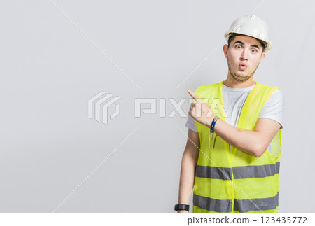 Surprised face construction worker pointing at an advertisement. Engineer man pointing to side. Surprised face engineer pointing finger to the right, Surprised engineer pointing to the side Surprised face construction worker pointing at an advertisement. Engineer man pointing to side. Surprised face engineer pointing finger to the right, Surprised engineer pointing to the side 123435772