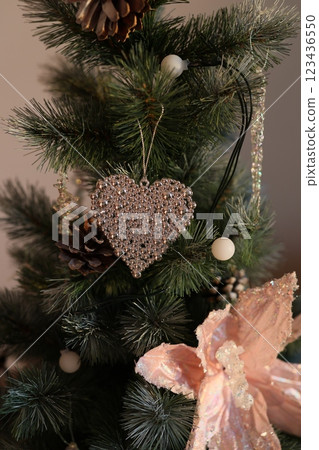 Stylish and Elegant Holiday Decor featuring Pine, a Heart Ornament, and a Decorative Bow 123436550