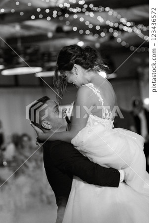 the first dance of the bride and groom inside a restaurant 123436572