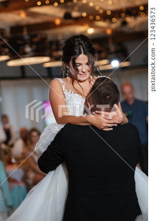 the first dance of the bride and groom inside a restaurant the first dance of the bride and groom inside a restaurant 123436573