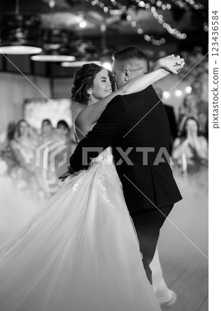 the first dance of the bride and groom inside a restaurant 123436584