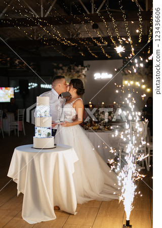 newlyweds happily cut and taste the wedding cake newlyweds happily cut and taste the wedding cake 123436606