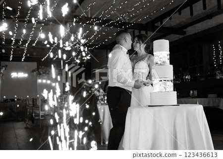 newlyweds happily cut and taste the wedding cake 123436613