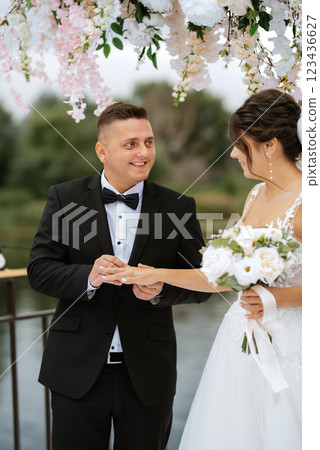 wedding ceremony of the newlyweds on the pier 123436627