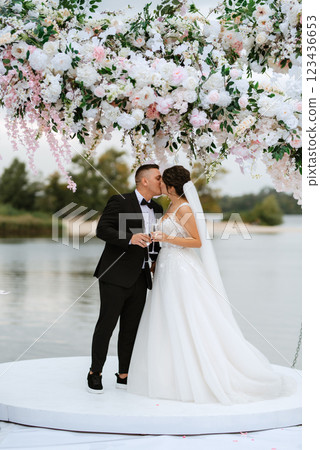 wedding ceremony of the newlyweds on the pier 123436653