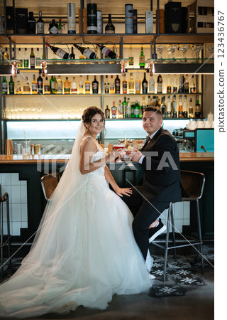bride and groom inside a cocktail bar bride and groom inside a cocktail bar 123436767