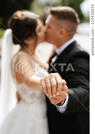 the groom in a brown suit and the bride in a white dress the groom in a brown suit and the bride in a white dress 123436814