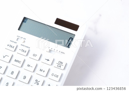 A white calculator on a white table A white calculator on a white table 123436856