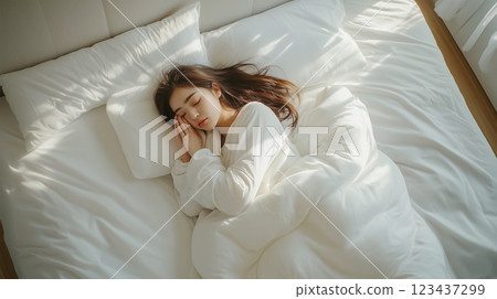 Woman sleeping in a spacious bed 123437299
