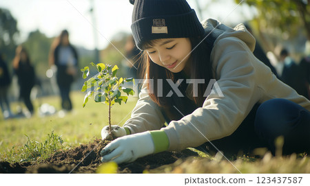 Young people in Japan are participating in tree planting activities to create forests of the future. 123437587