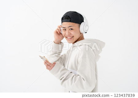 Male teenager portrait headphones smartphone Male teenager portrait headphones smartphone 123437839