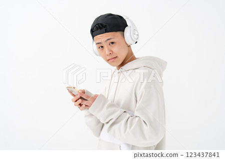 Male teenager portrait headphones smartphone 123437841