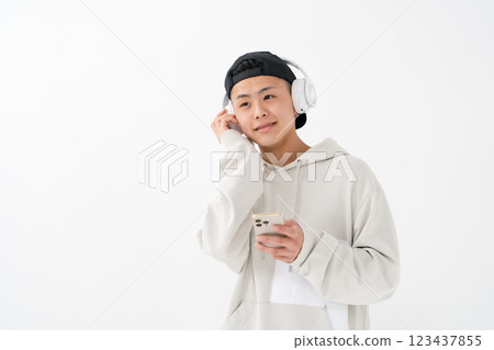 Male teenager portrait headphones smartphone Male teenager portrait headphones smartphone 123437855