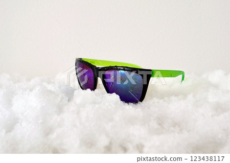 Colorful "old sunglasses" on the snow 123438117