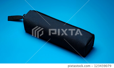 A black pencil case on a blue background 123439079