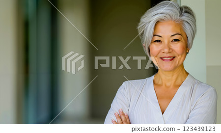 A woman with grey hair smiling at the camera A woman with grey hair smiling at the camera 123439123
