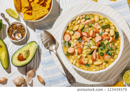 white bean chickpea chili with sausages, zucchini white bean chickpea chili with sausages, zucchini 123439379