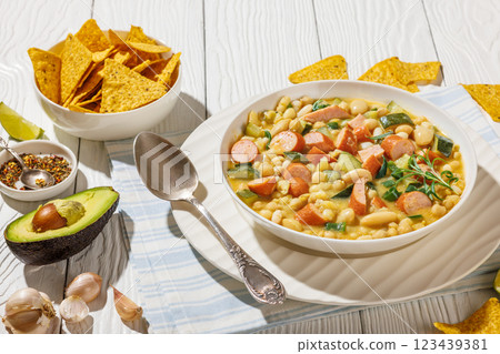 white bean chickpea chili with sausages, zucchini 123439381