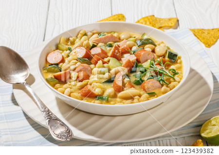 white bean chickpea chili with sausages, zucchini white bean chickpea chili with sausages, zucchini 123439382