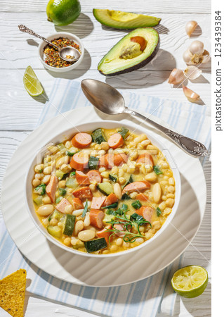 white bean chickpea chili with sausages, zucchini 123439384