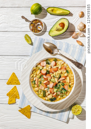 white bean chickpea chili with sausages, zucchini white bean chickpea chili with sausages, zucchini 123439385