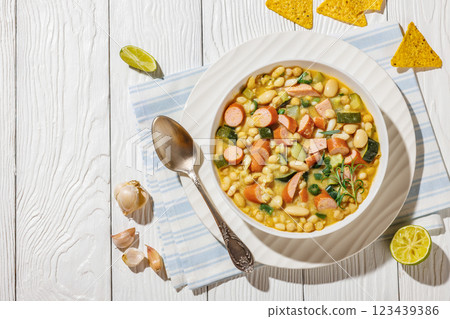 white bean chickpea chili with sausages, zucchini white bean chickpea chili with sausages, zucchini 123439386