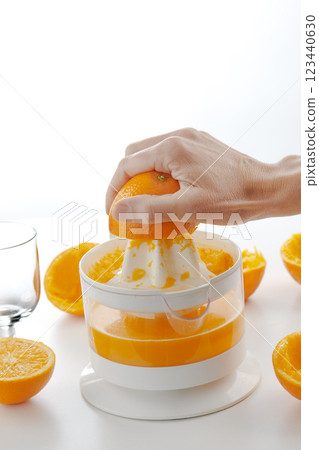 man preparing a natural orange juice 123440630