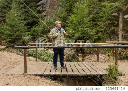 Young 30s blonde man hiking in nature. Travel, adventure. Concept of an active lifestyle. High quality photo. Fall autumn hiker man outdoor at nature forest. Full body Young 30s blonde man hiking in nature. Travel, adventure. Concept of an active lifestyle. High quality photo. Fall autumn hiker man outdoor at nature forest. Full body 123441414