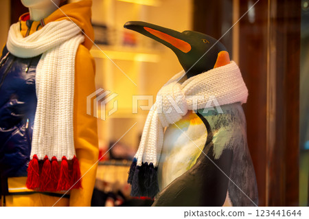 A funny toy penguin is wrapped in a warm scarf. 123441644