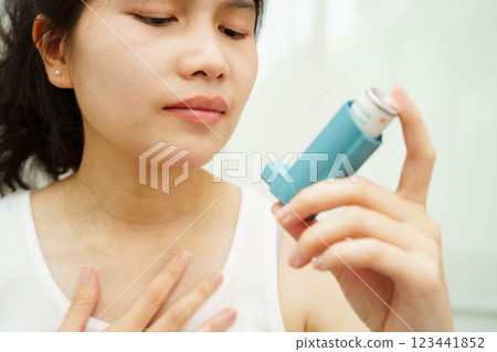 Asthma and chronic obstructive pulmonary disease COPD, Asian teenage using metered dose inhaler MDI. Asthma and chronic obstructive pulmonary disease COPD, Asian teenage using metered dose inhaler MDI. 123441852