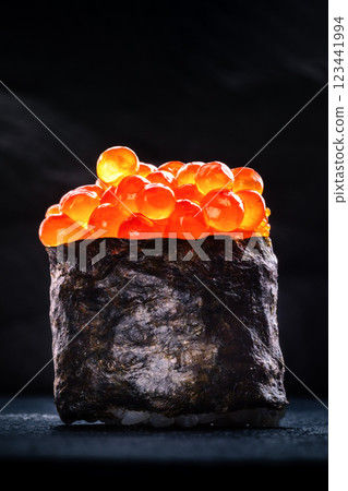 Ikura sushi maki roll on a black slate background Ikura sushi maki roll on a black slate background 123441994