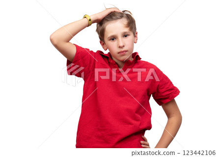 A teenager in a red T-shirt puts his hand on his head and looks at the camera. A teenager in a red T-shirt puts his hand on his head and looks at the camera. 123442106