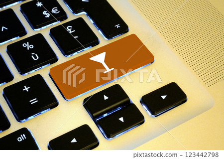 Cocktail glass key of a laptop 123442798