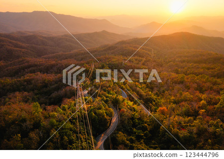 Mountain landscapes reveal scenic sunrises and sunsets painting the sky with clouds over forested hills and valleys 123444796