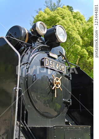 A steam locomotive stops against the blue sky A steam locomotive stops against the blue sky 123444801
