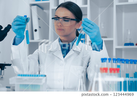Scientist Analyzing Test Tubes in a Laboratory Setting 123444969