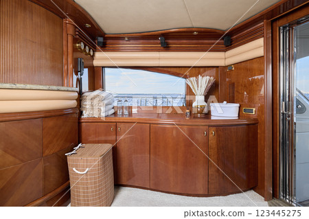 An Elegant Yacht Interior Featuring Beautiful Wood Accents and Scenic Views All Around An Elegant Yacht Interior Featuring Beautiful Wood Accents and Scenic Views All Around 123445275