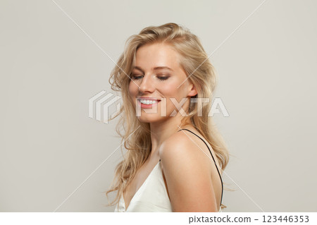Cute young blond female model with clear skin, soft make-up and healthy hair  123446353