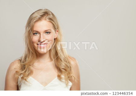 Happy blond woman with cute smile looking at camera. Beauty young adult person portrait 123446354