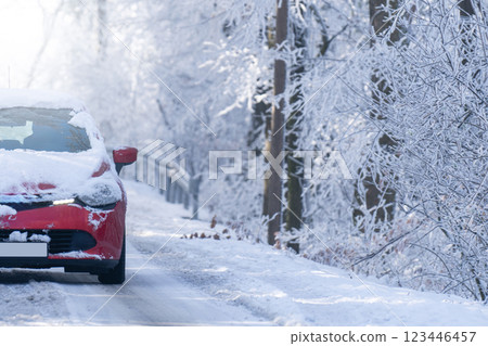 Car on a winter road through a snow covered forest 123446457