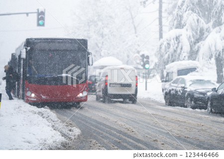 City bus on a city street during snowfall City bus on a city street during snowfall 123446466
